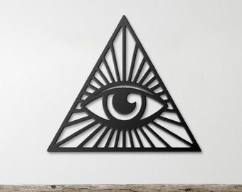 May include: Black metal wall art featuring an all-seeing eye inside a triangle with radiating lines.