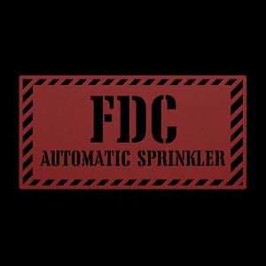 May include: A rectangular, red sign with the text "FDC AUTOMATIC SPRINKLER" in black. The sign has a black and white striped border and is set against a black background.