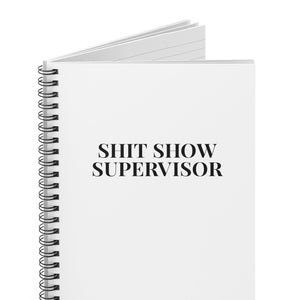 May include: White spiral-bound notebook with the text "SHIT SHOW SUPERVISOR" printed in black. The notebook is open, revealing lined pages. The spiral binding is black.