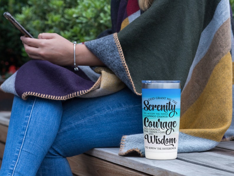 May include: A stainless steel tumbler with a blue and white ombre design. The tumbler features the text "God grant me the Serenity to accept the things I cannot change, Courage to change the things I can, and Wisdom to know the difference."