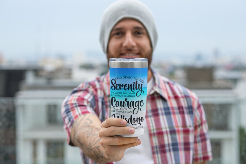 May include: A stainless steel tumbler with a blue and white ombre design. The tumbler features the text "God grant me the Serenity to accept the things I cannot change, Courage to change the things I can, and Wisdom to know the difference."