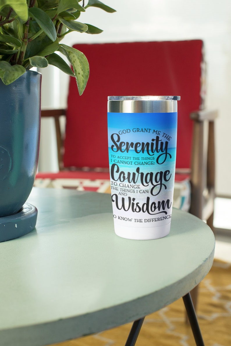 May include: Stainless steel tumbler with a blue and white beach scene and the text "God grant me the Serenity to accept the things I cannot change: Courage to change the things I can: Wisdom to know the difference."