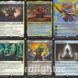 May include: A collection of ten Magic: The Gathering trading cards arranged in two rows of five. The cards feature various fantasy illustrations, including characters like Adeline, Resplendent Cathar, Elspeth, Sun's Champion, and Teysa Karlov, alongside text blocks detailing game rules and card names.