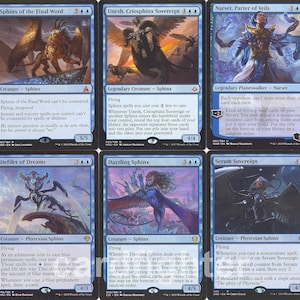 May include: A collection of nine Magic: The Gathering cards featuring various Sphinx creatures. The cards are blue and black with intricate artwork and text. The cards are from the set 'New Phyrexia'.