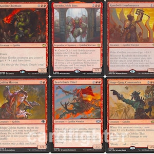 May include: A collection of ten red Magic: The Gathering trading cards arranged in two rows. Each card features unique fantasy goblin illustrations, descriptive text, and game statistics. The cards include Krenko, Tin Street Kingpin, Goblin Chieftain, Krenko, Mob Boss, Rundvelt Hordemaster, Goblin Warchief, Goblin Bombardment, Goblin Matron, Beetleback Chief, Siege-Gang Commander, and Shared Animosity.