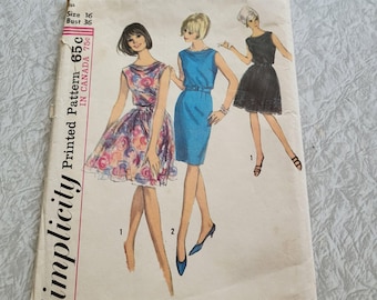 May include: Simplicity Printed Pattern 65c, a vintage sewing pattern for a dress. The pattern shows three different styles of dresses: a floral print dress, a blue dress with a belt, and a black dress with lace trim. The pattern is for size 16, bust 36.