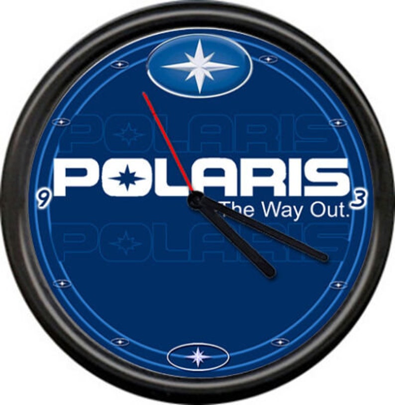 May include: A black wall clock with a blue face featuring the Polaris logo and the text "The Way Out". The clock has a white star in the center and a red second hand.
