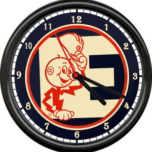 May include: A black wall clock with a white face and black hands. The clock face features a cartoon character with a lightning bolt and the letter "E" in a red, white, and blue design.