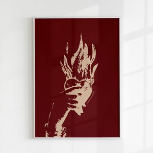 May include: A stylized illustration of a hand holding a heart engulfed in flames. The image is set against a deep red background.