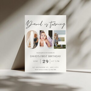 May include: A white invitation card with the text "David is turning ONE" in a stylish font. The word "ONE" features three photos of a baby. The card also includes the text "David's First Birthday" and event details.