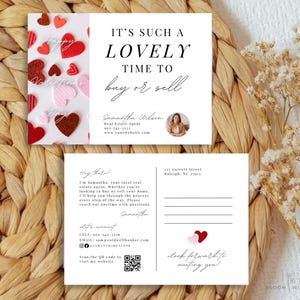 May include: A Valentine's Day themed real estate postcard with a red and pink heart design. The text reads "It's such a lovely time to buy or sell". The postcard includes the real estate agent's name, contact information, and website address.