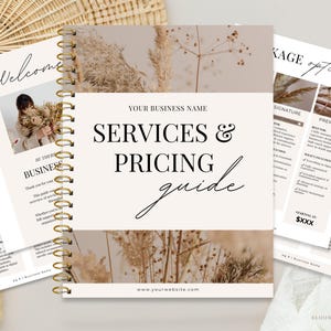 May include: A spiral-bound notebook with a gold coil, featuring a beige cover with the text "SERVICES & PRICING guide." The notebook is open, displaying pages with text and images, including "Welcome" and "PACKAGE options."