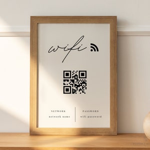 Pode incluir: Uma impressão emoldurada com um código QR preto e branco, as palavras "wifi" e um símbolo de wifi, e o texto "NETWORK network name" e "PASSWORD wifi password".