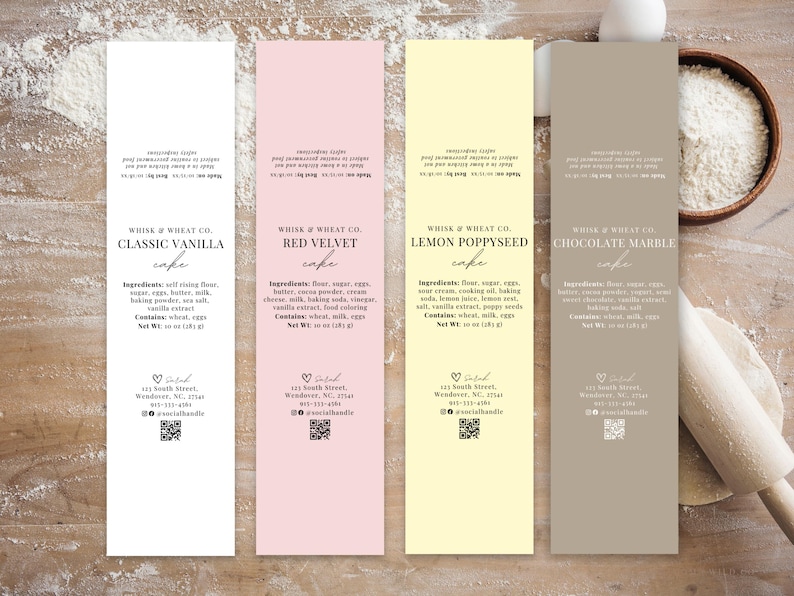 May include: Four different cake labels with a white background and black text. The labels are for Classic Vanilla, Red Velvet, Lemon Poppyseed, and Chocolate Marble cakes. Each label includes the ingredients, net weight, and contact information for Whisk & Wheat Co.