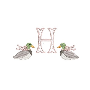 May include: Embroidered design featuring the letter H in pink with two ducks on either side. The ducks are gray with green heads and pink ribbons.