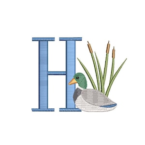 May include: Embroidered design featuring a blue letter "H" with a duck, cattails, and reeds. The duck has a green head, yellow beak, and gray and white body. The cattails are brown, and the reeds are green.