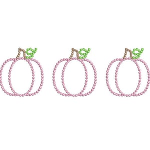 May include: Three pink pumpkins with green stems and leaves. The pumpkins are made of beads and are arranged in a row.