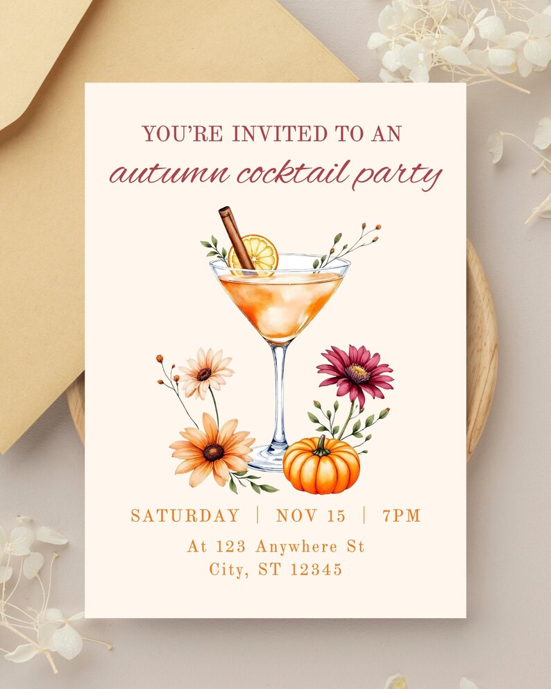 May include: An invitation for an autumn cocktail party. The design features a cocktail in a martini glass with a cinnamon stick and lemon slice. Orange and burgundy flowers and a small pumpkin are also included. The text reads: "YOU'RE INVITED TO AN autumn cocktail party".