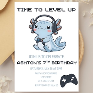 May include: A white invitation card with the text "TIME TO LEVEL UP" and "JOIN US TO CELEBRATE ASHTON'S 7TH BIRTHDAY". It features a cartoon axolotl wearing headphones and holding a game controller. A black game controller icon is at the bottom.