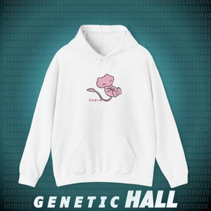 May include: White hooded sweatshirt featuring a pink cartoon character and Japanese text. The hoodie has a front pocket and a drawstring. The text "GENETIC HALL" is at the bottom.