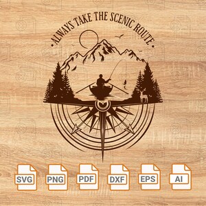 May include: A brown compass with a mountain scene and the text "Always Take The Scenic Route". The compass is surrounded by a circle of trees and a deer. The image is on a woodgrain background.