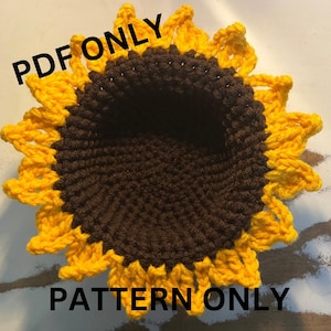 May include: Crochet pattern for a sunflower, with the text "PDF ONLY PATTERN ONLY" on the image.