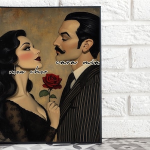 May include: A vintage-style print depicting a man and woman in a romantic pose. The woman holds a red rose. The man wears a pinstripe suit. The words "mon cher" and "cara mia" are written on the print.