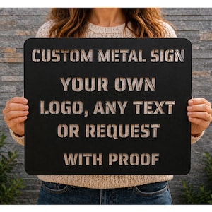 May include: Black metal sign with cut-out text. The sign reads "CUSTOM METAL SIGN YOUR OWN LOGO, ANY TEXT OR REQUEST WITH PROOF". The sign is rectangular with rounded corners and is held by a person.