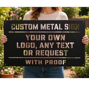 May include: A black metal sign with cut-out text that reads "CUSTOM METAL SIGN YOUR OWN LOGO, ANY TEXT OR REQUEST WITH PROOF." The sign is rectangular with rounded corners and is held up in front of a green background.