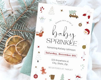 May include: A white baby sprinkle invitation with a red and green Christmas theme. The invitation features a festive illustration of a baby carriage with a Christmas tree on top, a snowman, a reindeer, and a gingerbread man. The text on the invitation reads "Please join us for a baby sprinkle honouring Kelsey Johnson, Saturday, December 8th, 123 Anywhere st. City, State, Zip, Registered at Target."