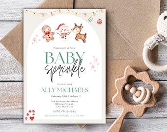 May include: A light beige baby shower invitation with a green and white border. The invitation features a gingerbread man, snowman, and reindeer with a string of lights and snowflakes. The text reads "Please join us for a Baby Sprinkle honouring Ally Michaels February 20th | 1:00pm The Michaels Residence 123 anywhere st. City, State, Zip registered at baby baby PLEASE RSVP TODANIELLE AT 123 456 7890"