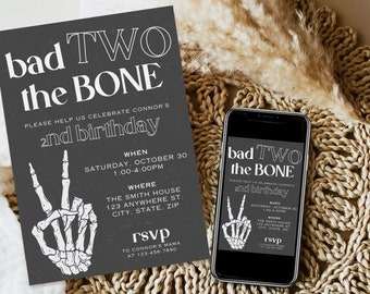 May include: Black and white invitation with a skeleton hand making a peace sign. The text reads "bad TWO the BONE please help us celebrate Connor's 2nd birthday" with details about the event, including the date, time, and location. RSVP information is included at the bottom.