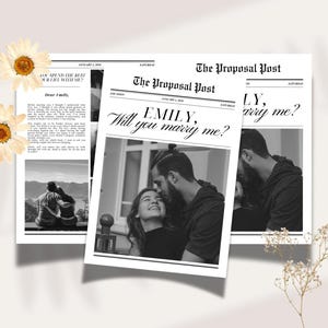 May include: Newspaper-style proposal announcement with the headline "EMILY, Will you marry me?" in a classic font. The black and white image features a couple and the text "Dear Emily". Decorative flowers are placed around the announcement.