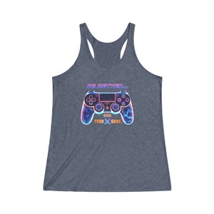 May include: A heather blue tank top with a graphic of a neon blue and purple video game controller. The text "BE BETTER... BRING YOUR X GAME" is printed on the tank top.