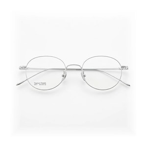 May include: Silver-framed eyeglasses with round lenses. The glasses have a thin, minimalist design with a bridge and temples. The text "Titanium Temple" is printed on the left lens. The overall aesthetic is modern and sleek.