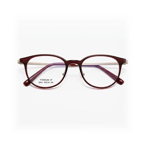 May include: A pair of eyeglasses with a burgundy frame and gold-colored temples. The lenses are clear, and the frame has a rounded shape. The text "TITANIUM - IP 2455 50□19-145" is printed on the frame.