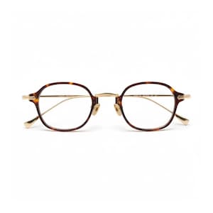 May include: Round eyeglasses with a tortoiseshell pattern frame and gold-colored metal accents. The glasses have a classic design with a keyhole bridge and thin temples. The lenses are clear, and the overall style is vintage-inspired.