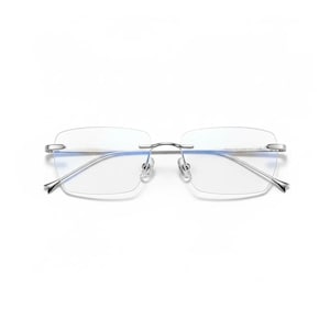 May include: Rimless eyeglasses with rectangular lenses and a silver metal bridge and temples. The lenses are clear, and the frame has a minimalist design. The temples have a subtle, pointed end.