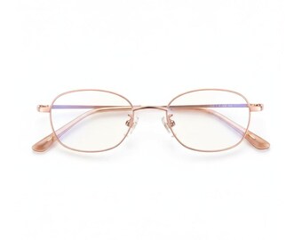 May include: Rose gold-colored eyeglasses with a rounded rectangular frame. The glasses have clear lenses and a delicate, minimalist design. The temples and nose bridge are thin and elegant, creating a modern aesthetic. The overall style is suitable for everyday wear.