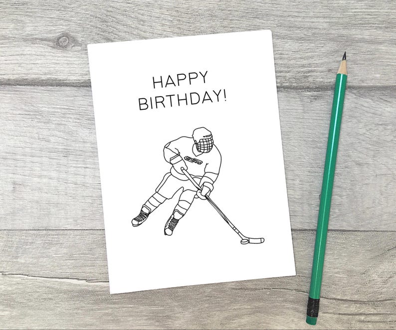 May include: A black and white illustration of a hockey player on a white card with the text "Happy Birthday!" printed on it.