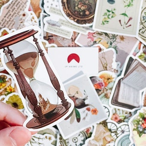 May include: A sticker featuring a detailed hourglass design with brown wooden supports and a clear glass center filled with sand. The sticker is surrounded by other vintage-themed stickers, including floral and antique elements.