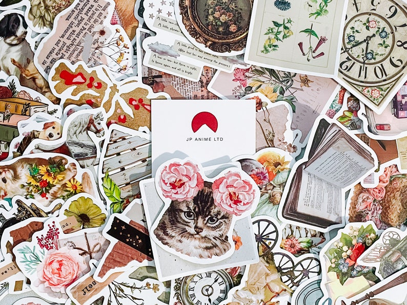 May include: A collection of vintage-style stickers with various designs, including floral arrangements, a cat with flower accents, a clock face, and text. The stickers have a distressed, aged appearance, with a mix of colors and illustrations.