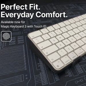May include: A white wireless keyboard with a dark gray frame and a small black attachment on the front edge. The text on the image reads: Perfect Fit. Everyday Comfort. Available now for Magic Keyboard 3 with Touch ID. A fingerprint icon is visible.
