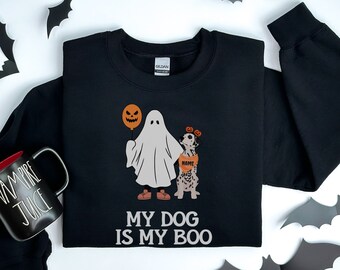 May include: Black sweatshirt with a ghost and a dog wearing a pumpkin hat. The text on the sweatshirt says "My dog is my boo".