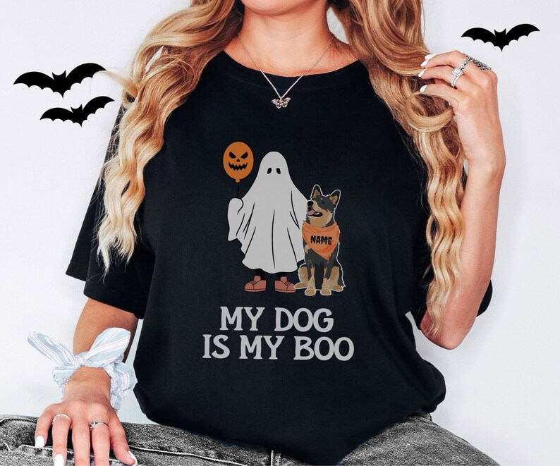 a woman wearing a black shirt with a dog and a ghost on it