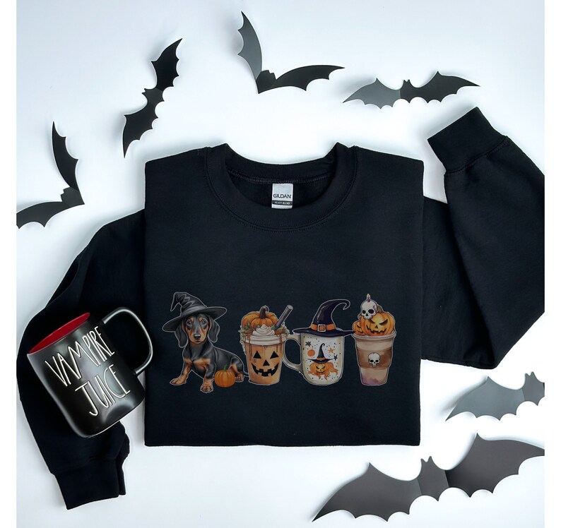 a black shirt with three cups of coffee and bats