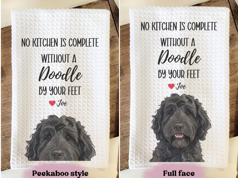 two towels with a humorous message about a dog. The towels feature a cartoon image of a dog's face and the text "No kitchen is complete without a Doodle by your feet Joe" along with the text "Peekaboo style" and "Full face" indicating the style of the towel.