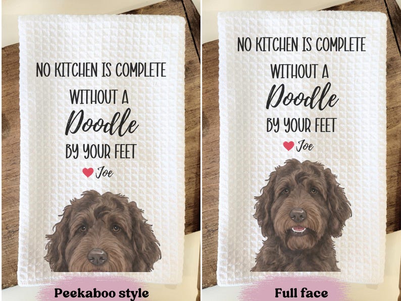two towels with a dog's face on them. The towels are labeled with a humorous message about a kitchen and a dog.