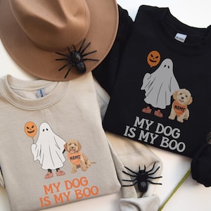 May include: Two tan and black sweatshirts with a ghost and dog graphic. The text on the sweatshirts reads "My dog is my boo".