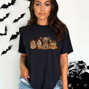 a woman wearing a black t - shirt with a picture of a dog in a